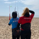 Anne houdt student vast tijdens de les kitesurfen bij Surfschool Castricum. Kitesurf kite besturen.